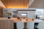 This stunning modern kitchen boasts a sleek design with light wood cabinets and a large island, perfect for entertaining.