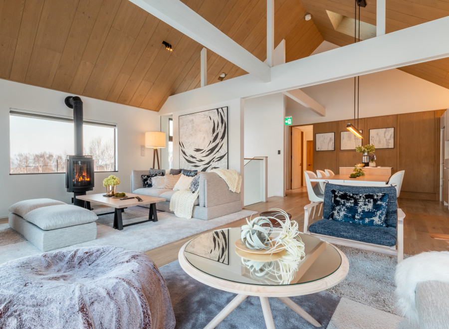 This stunning property boasts a spacious open-plan living area with vaulted ceilings and large windows offering breathtaking views.