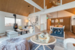 This stunning property boasts a spacious open-plan living area with vaulted ceilings and large windows offering breathtaking views.