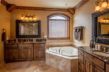 This luxurious bathroom boasts a spacious corner jacuzzi tub, perfect for relaxation.