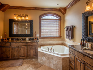 This luxurious bathroom boasts a spacious corner jacuzzi tub, perfect for relaxation.