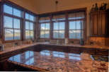 This stunning kitchen boasts breathtaking mountain views from its expansive windows, creating a bright and airy atmosphere.