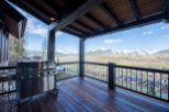 Luxury mountain retreat with expansive deck boasting breathtaking views.