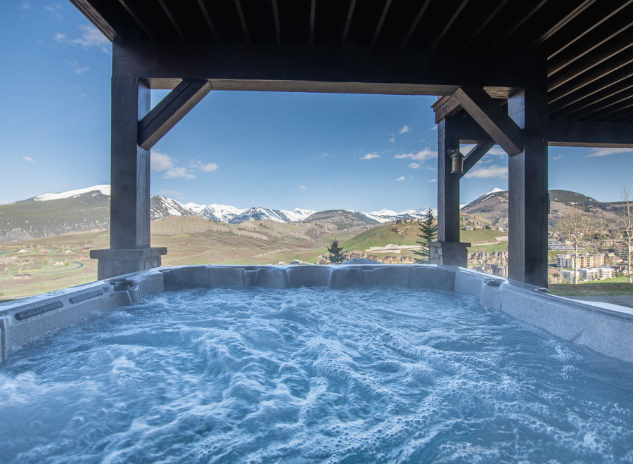 Luxury mountain getaway with a private hot tub offering breathtaking views.