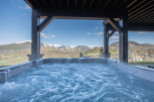 Luxury mountain getaway with a private hot tub offering breathtaking views.