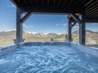 Luxury mountain getaway with a private hot tub offering breathtaking views.
