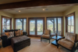 Mountain view living room with large windows and comfortable seating.