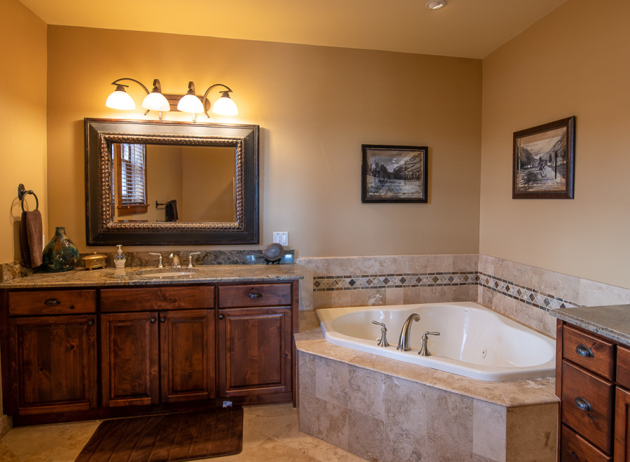 This luxurious bathroom boasts a spacious corner tub, perfect for relaxation.