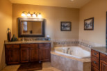 This luxurious bathroom boasts a spacious corner tub, perfect for relaxation.