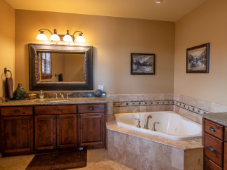 This luxurious bathroom boasts a spacious corner tub, perfect for relaxation.