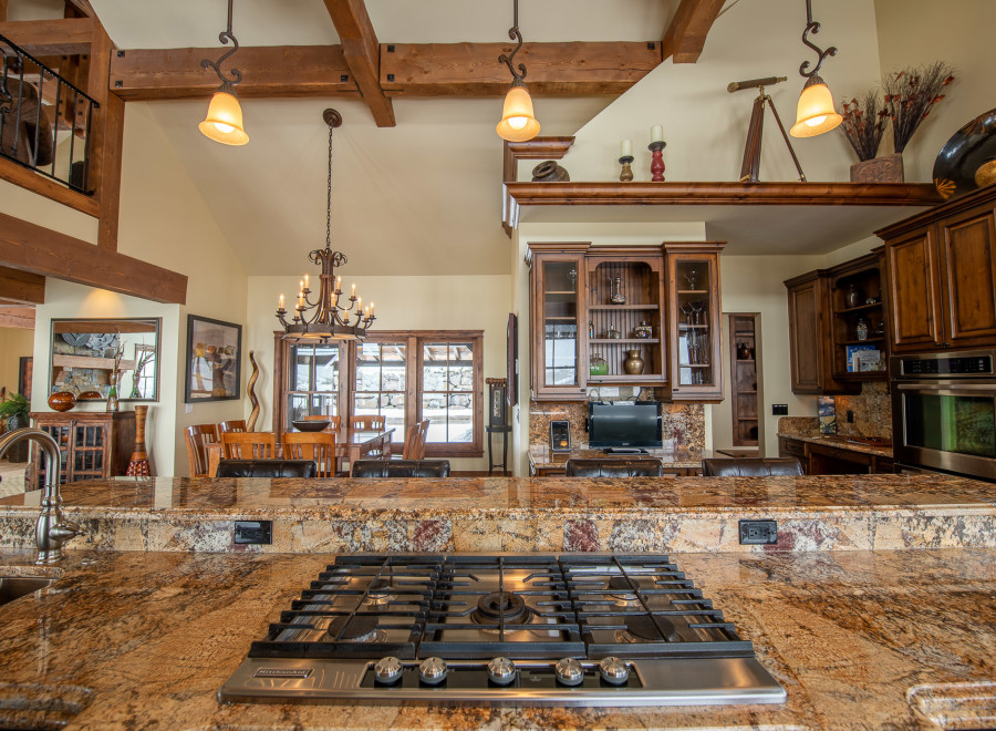 This stunning kitchen boasts a large granite island with a built-in gas cooktop, perfect for entertaining.