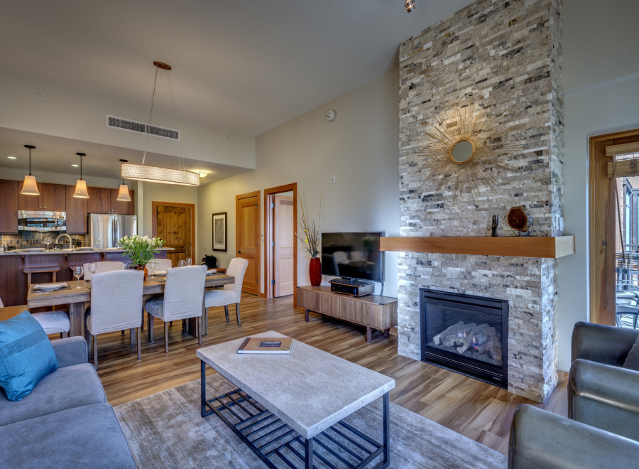 Experience luxury living in this stunning property, featuring a cozy fireplace and a stylish dining area perfect for entertaining.