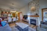 Experience luxury living in this stunning property, featuring a cozy fireplace and a stylish dining area perfect for entertaining.