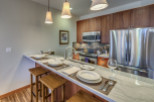 This stunning kitchen boasts a modern design with a sleek marble countertop and elegant pendant lighting.