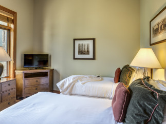 Cozy bedroom with two beds, perfect for a comfortable stay.