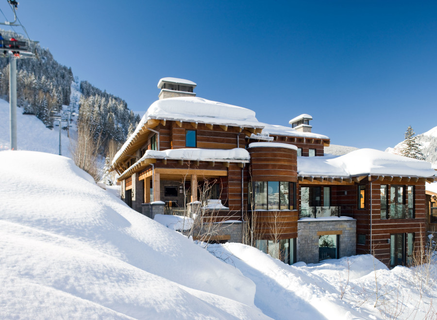 This stunning mountain home boasts a luxurious design with a warm, inviting aesthetic.