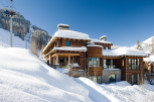 This stunning mountain home boasts a luxurious design with a warm, inviting aesthetic.