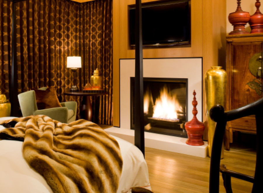 This luxurious bedroom boasts a cozy fireplace, perfect for relaxing evenings.