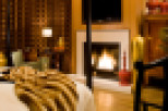 This luxurious bedroom boasts a cozy fireplace, perfect for relaxing evenings.