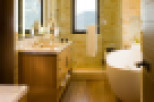 This luxurious bathroom boasts a modern design with warm, inviting tones.