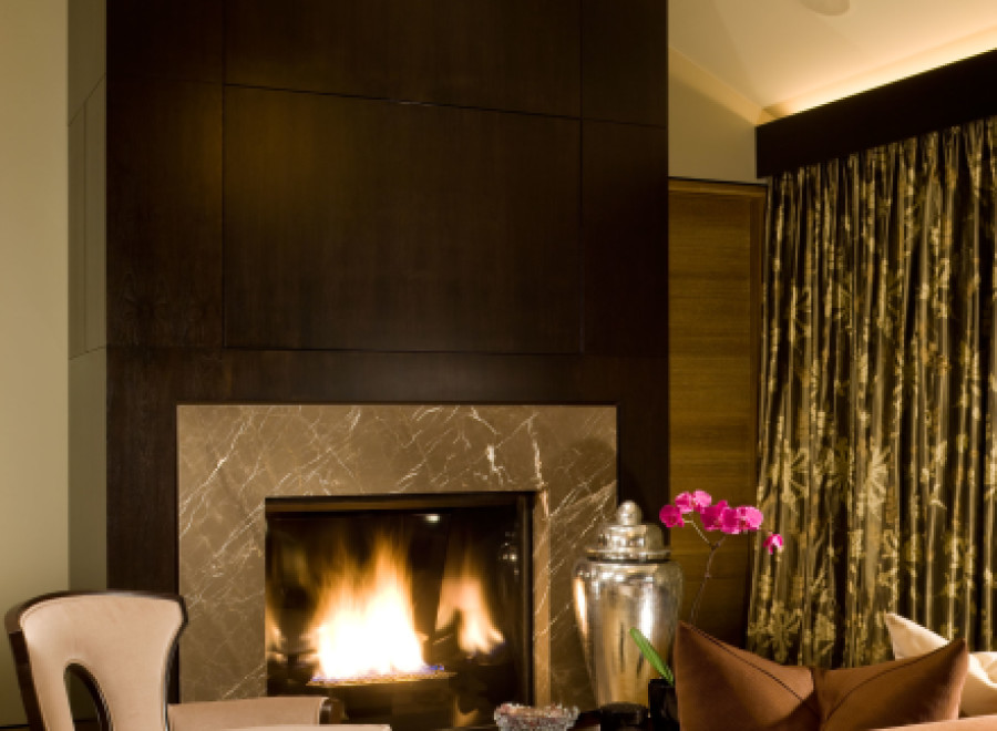 Experience luxury in this stunning living space, featuring a cozy fireplace and elegant seating.