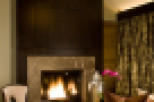 Experience luxury in this stunning living space, featuring a cozy fireplace and elegant seating.