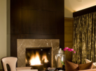 Experience luxury in this stunning living space, featuring a cozy fireplace and elegant seating.