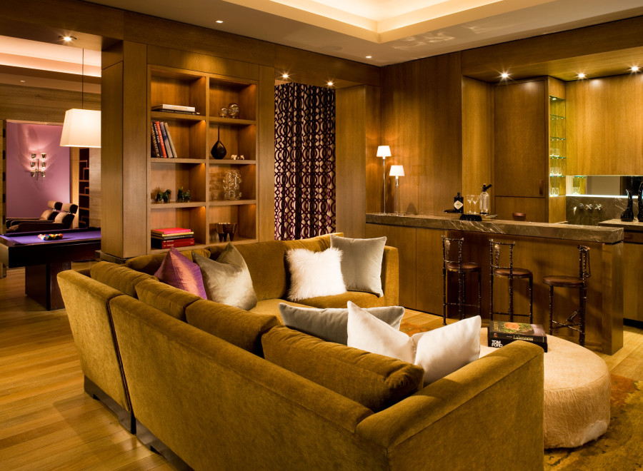 This luxurious living space features a cozy, mustard-colored sectional sofa, perfect for relaxation.