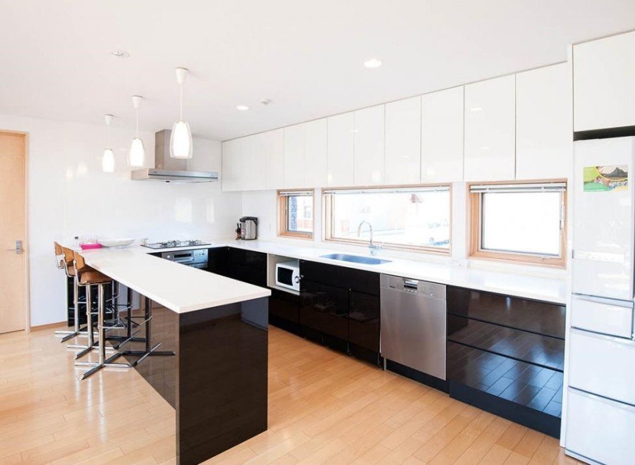 This stunning kitchen boasts a sleek, modern design with white and black cabinetry, creating a sophisticated atmosphere.