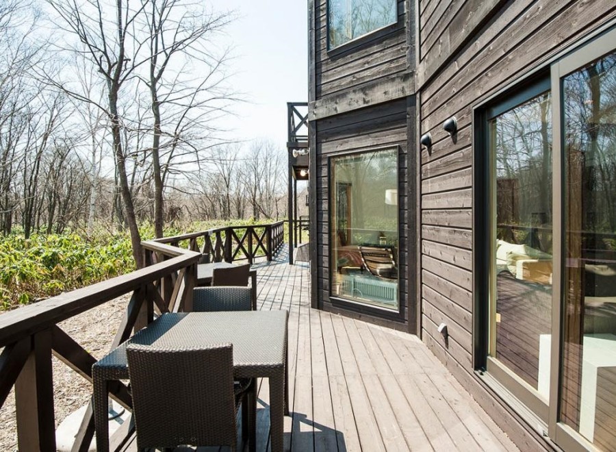 This stunning property boasts a spacious deck overlooking a serene forest, perfect for outdoor relaxation.