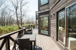 This stunning property boasts a spacious deck overlooking a serene forest, perfect for outdoor relaxation.