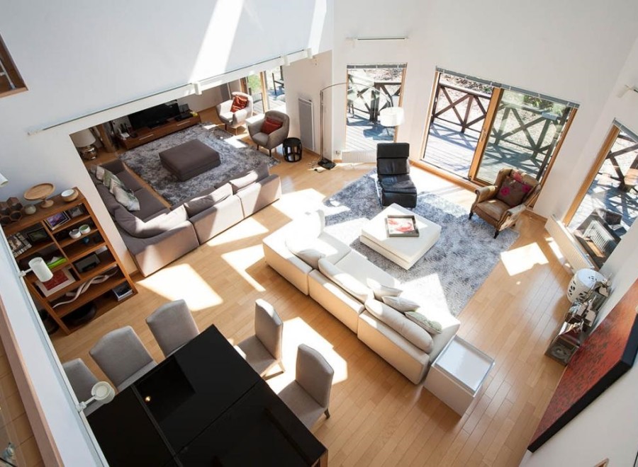 This stunning home boasts a spacious open-plan living area with hardwood floors and abundant natural light.