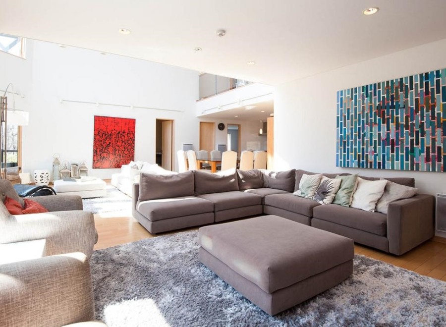 This stunning property boasts a spacious open-plan living area with floor-to-ceiling windows, allowing ample natural light to flood the room.