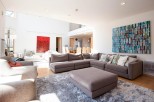 This stunning property boasts a spacious open-plan living area with floor-to-ceiling windows, allowing ample natural light to flood the room.