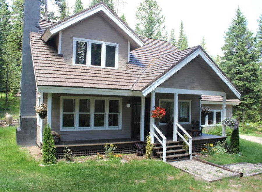 Charming two-story home nestled in a serene, wooded setting.