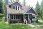 Charming two-story home nestled in a serene, wooded setting.