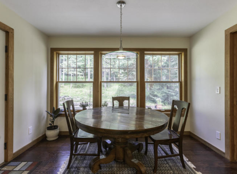 This charming dining area features a beautiful round wooden table, perfect for intimate gatherings.