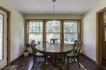 This charming dining area features a beautiful round wooden table, perfect for intimate gatherings.