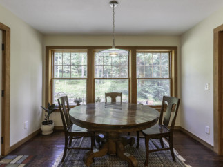 This charming dining area features a beautiful round wooden table, perfect for intimate gatherings.