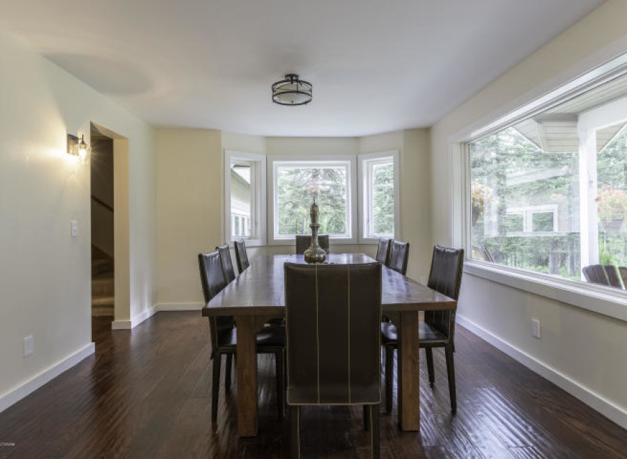 Elegant dining room with a large wooden table and comfortable leather chairs.