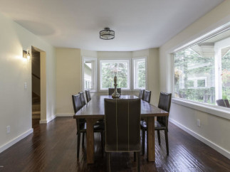 Elegant dining room with a large wooden table and comfortable leather chairs.