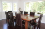 This stunning dining room features a large wooden table, perfect for hosting gatherings.