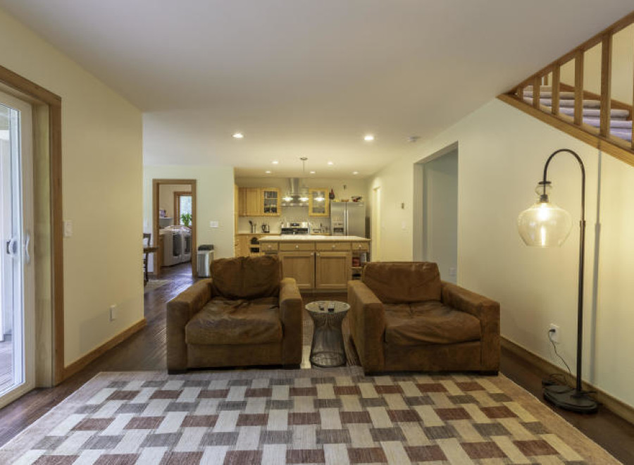 Step into this inviting living space, featuring two cozy armchairs and a stylish area rug.