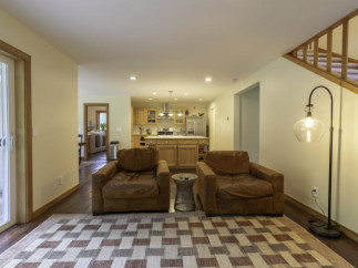 Step into this inviting living space, featuring two cozy armchairs and a stylish area rug.