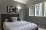 This cozy bedroom features a comfortable bed with plush pillows, perfect for a relaxing retreat.