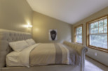 Discover the charm of this inviting bedroom, featuring a cozy bed and a stylish design.