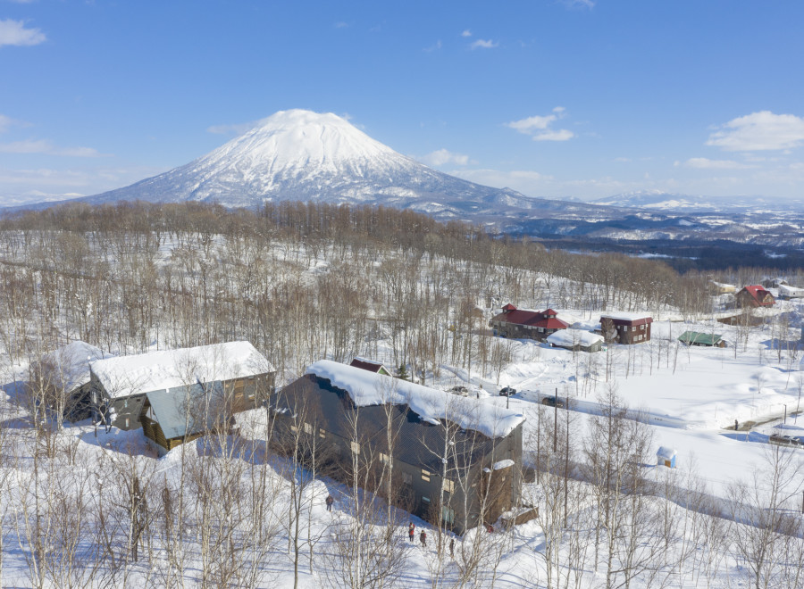 Nestled in a snowy landscape, this stunning property offers breathtaking views of a snow-capped volcano.