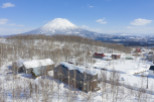 Nestled in a snowy landscape, this stunning property offers breathtaking views of a snow-capped volcano.