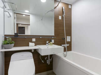 Modern bathroom with a sleek, white bathtub and toilet.
