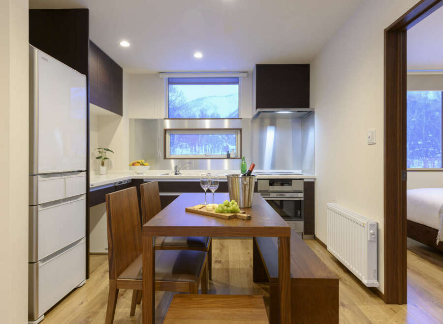 This stunning condo boasts a fully equipped kitchen with modern appliances and a spacious dining area, perfect for entertaining guests.